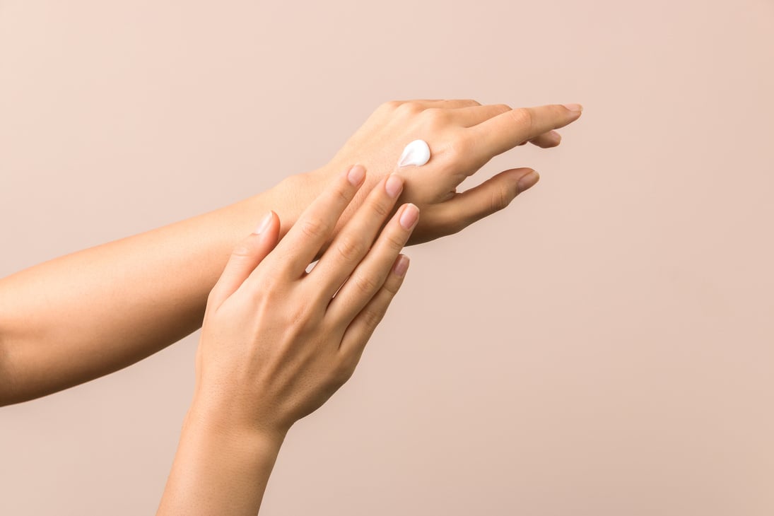 skincare. close up view of woman hand moisturising them with cream. skincare